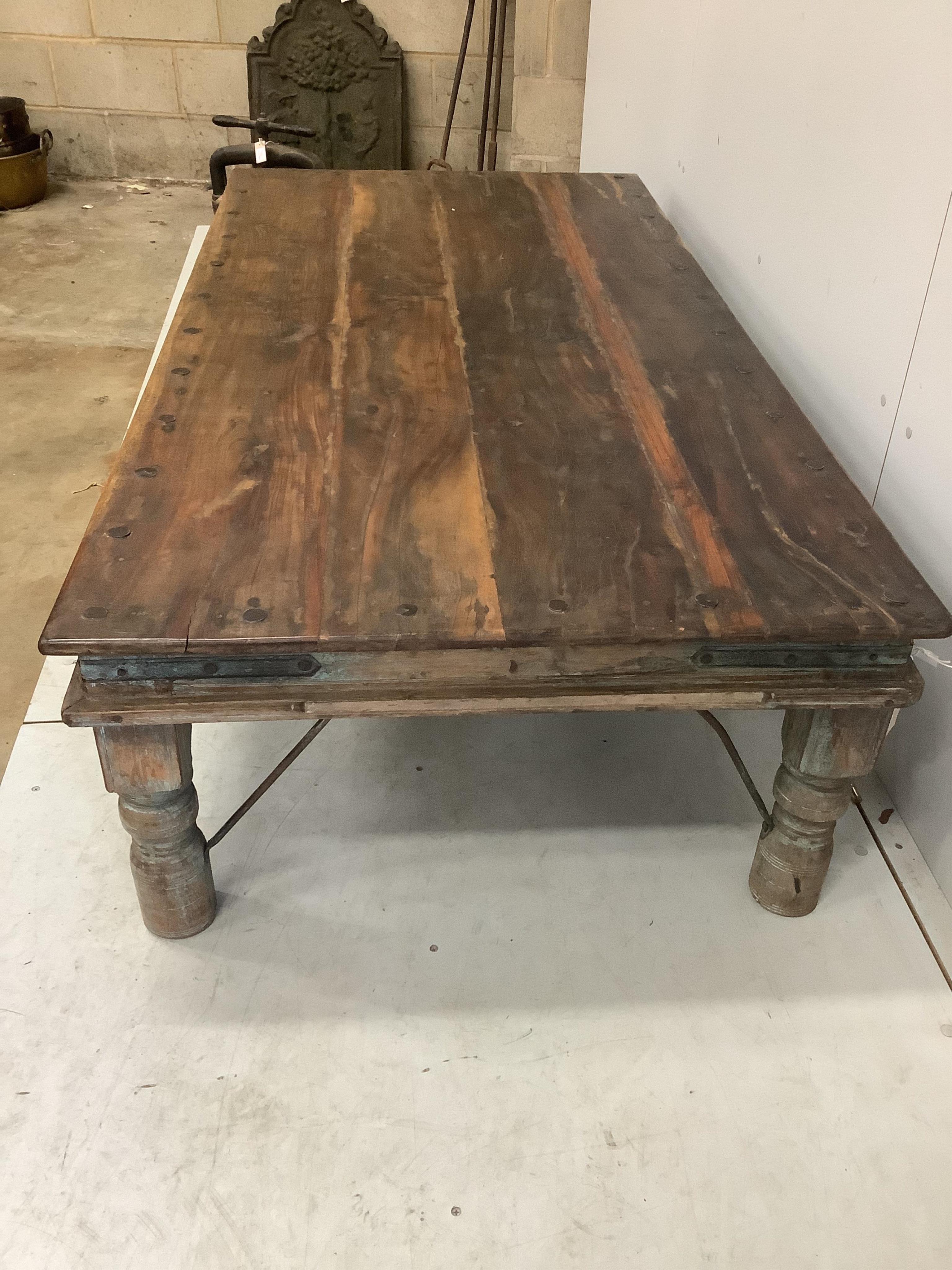 An Indian rectangular iron studded low hardwood coffee table, width 174cm, depth 90cm, height 46cm. Condition - fair